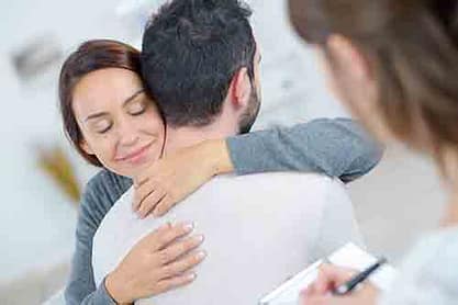 woman helps man seek opioid addiction treatment.