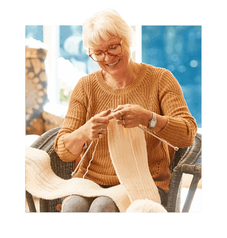 Senior sitting down knitting