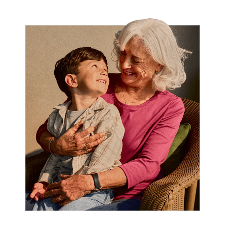 Senior smiling while holding grandchild