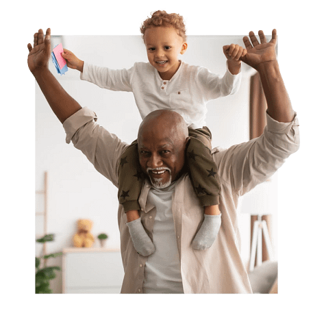 Senior with grandchild on shoulders