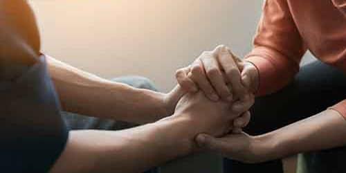 hands holding hands for mental wellness month