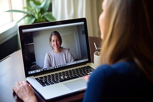woman talks with therapist through telehealth treatment