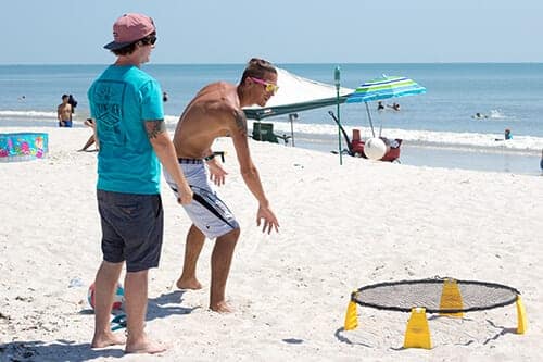 Two young men playing on the beach