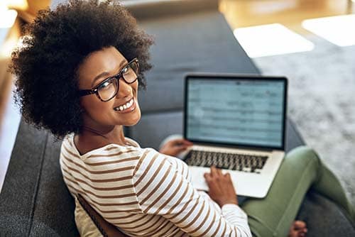 Woman smiles while looking at the patient portal