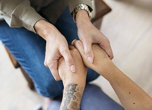 Clasping hands at Gainesville drug rehab centers