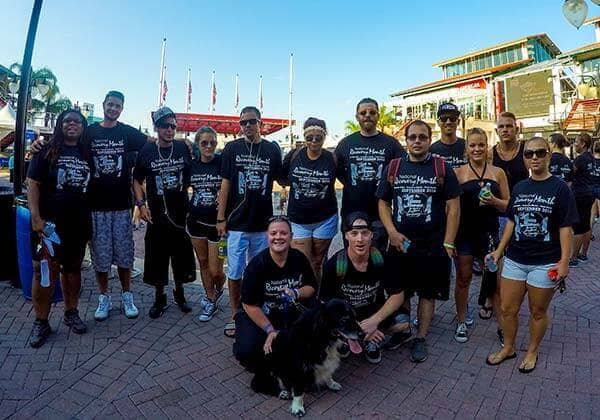Happy Beaches Recovery patients posing in front of a stadium