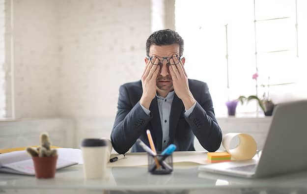 man with head in his hands is experiencing tramadol addiction symptoms