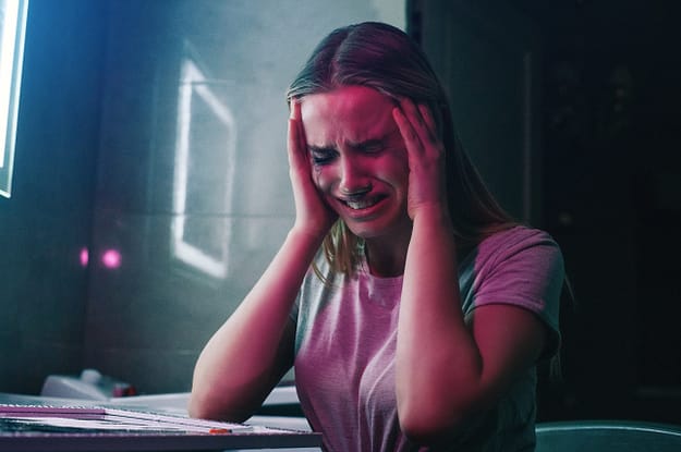 woman holding her head and crying from symptoms of heroin addiction needing a heroin detox center in florida