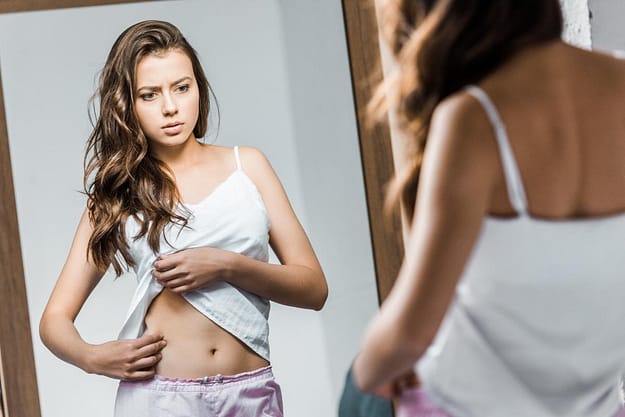 Young woman contemplating the long-term effects of anorexia