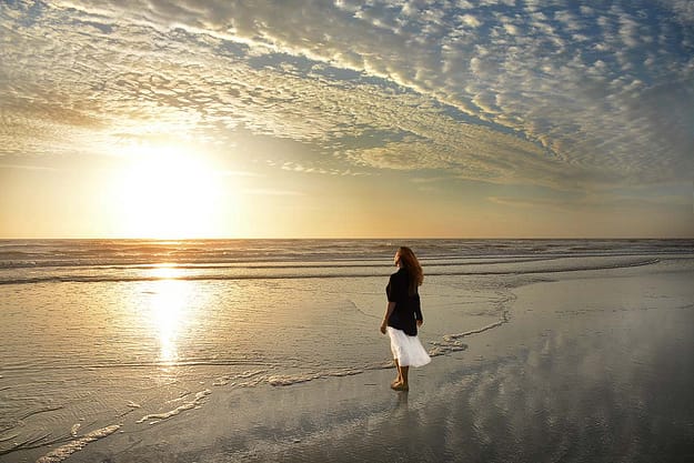 woman watching the sunset at the beach after a Jacksonville addiction treatment program