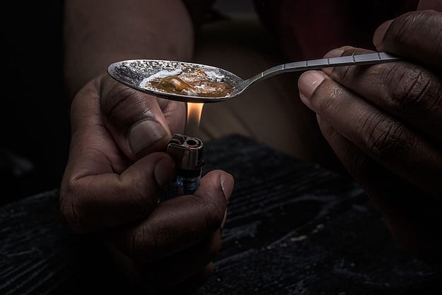 close up of heroin being heated up in spoon showing the need for heroin addiction rehab for teens