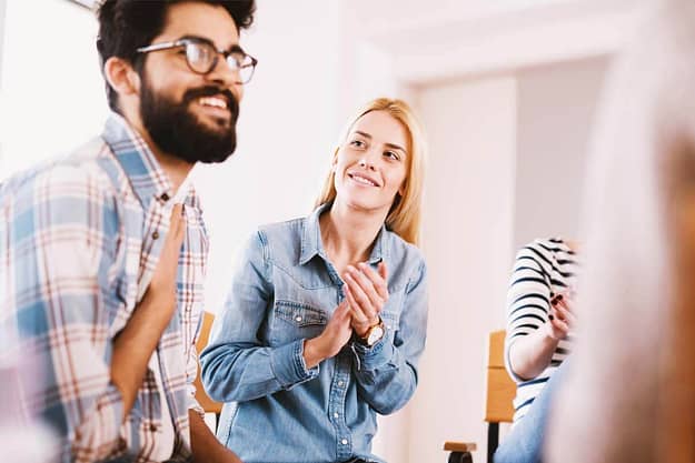 man smiling in group at drug abuse treatment programs