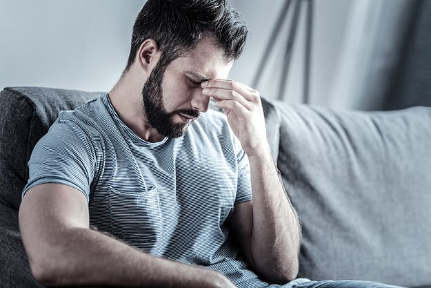 man pinching his nose wondering What Is Drug Abuse