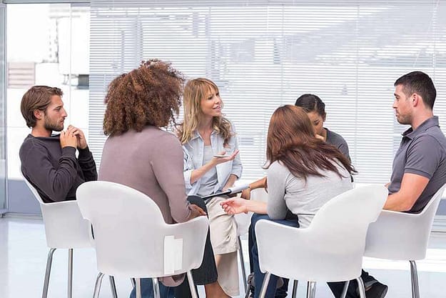 Patients sitting in a circle for a group therapy session