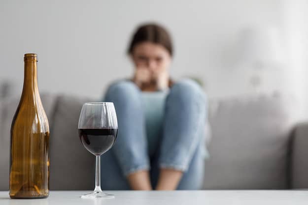 woman sitting looking at wine