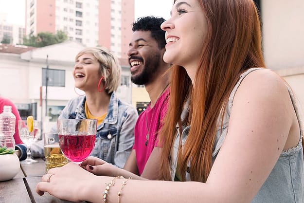 three people drinking in college