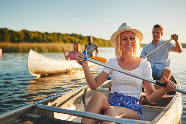 a woman canoeing while enjoying fun sober activities