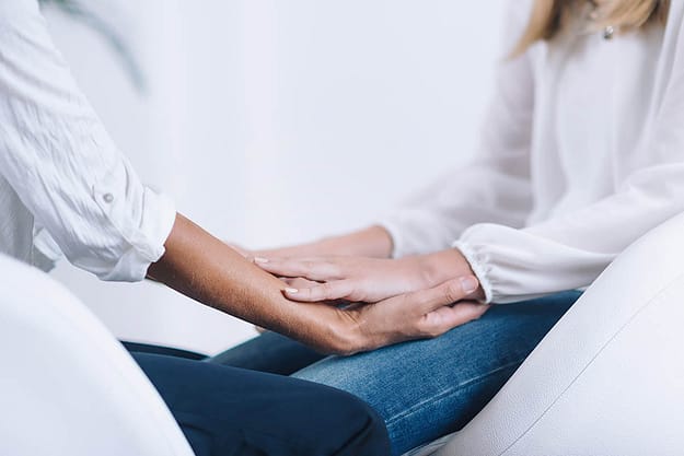 people holding hands practicing mindfulness training