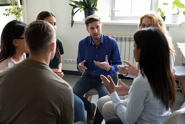 man talking in a group