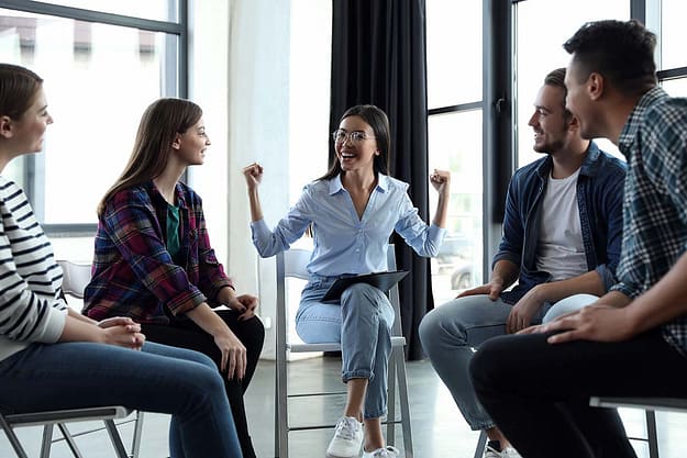 a group of people sit in group therapy at a heroin rehab center atlanta ga