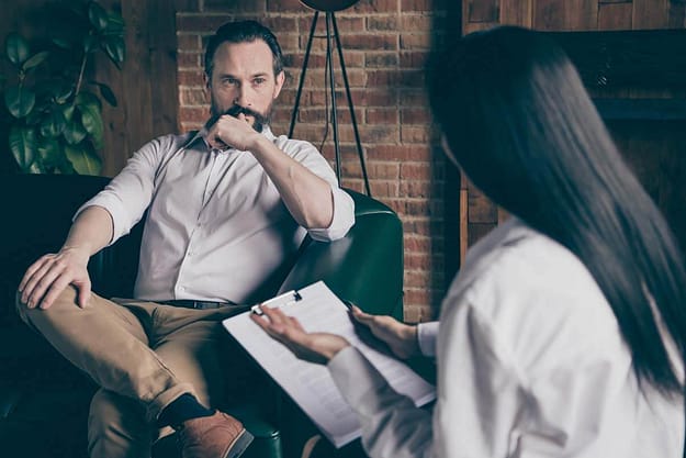 specialist talking to man about Jacksonville Heroin Addiction Treatment Program