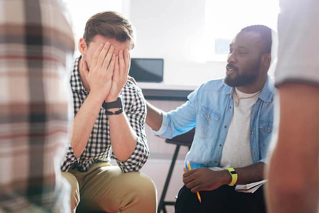 sad man covering face at the Jacksonville Men’s Rehab Program