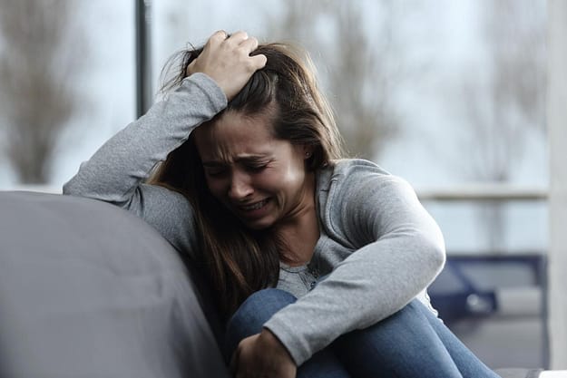 stress out woman crying from learning the risk factors for addiction