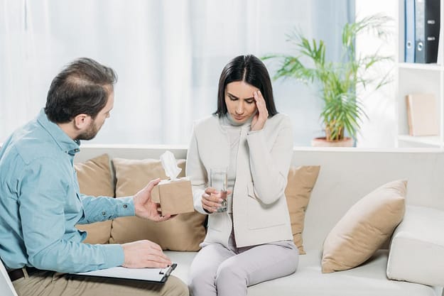 woman talking to male on couch