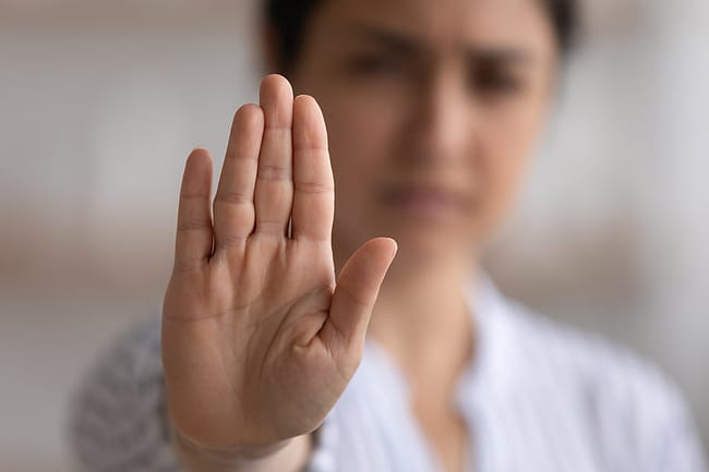 Woman putting hand up using an opioid refusal strategy