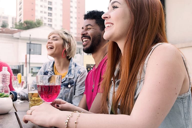 three people drinking in college