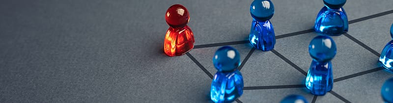 red and blue figurines displaying leadership, connection, and teamwork