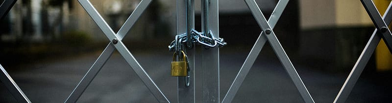 A chain and padlock securing a fence gate, symbolizing data protection and security standards like HITRUST certification within healthcare