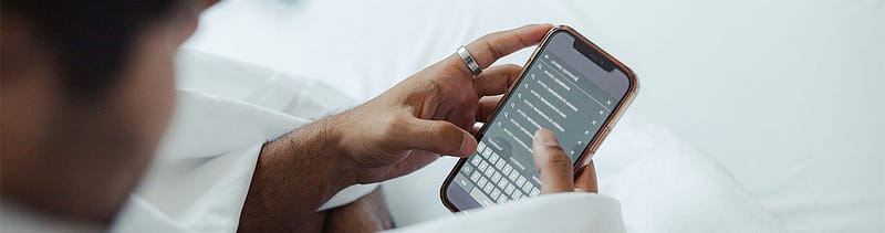 Man using a phone to search online, highlighting how SEM strategy remains vital for healthcare marketers adapting to AI.