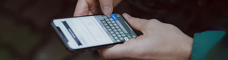 A person taking a health risk assessment on their phone, representing the link between prevention and patient acquisition.