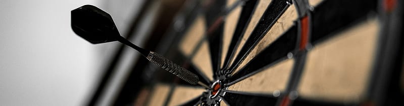 dart board with a dart in the bullseye