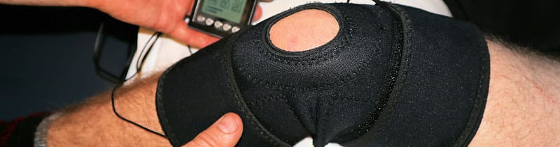 a person wearing a knee brace visits an orthopedic specialist for consultation symbolizing the need for strong service line marketing to reach your patients
