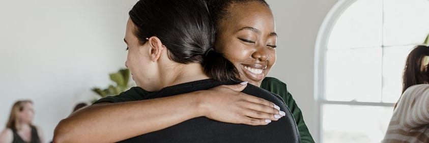 two people hug in a professional detox center setting