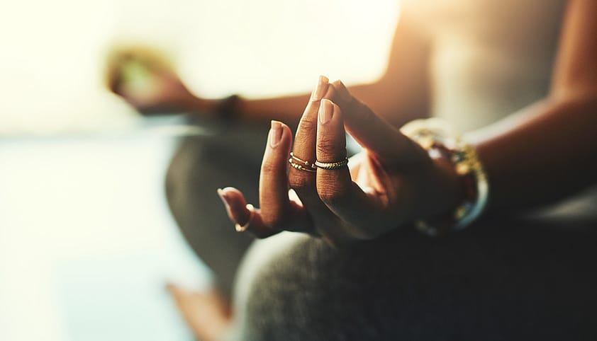 Woman sits and medicates as she learns about a holistic approach to treatment