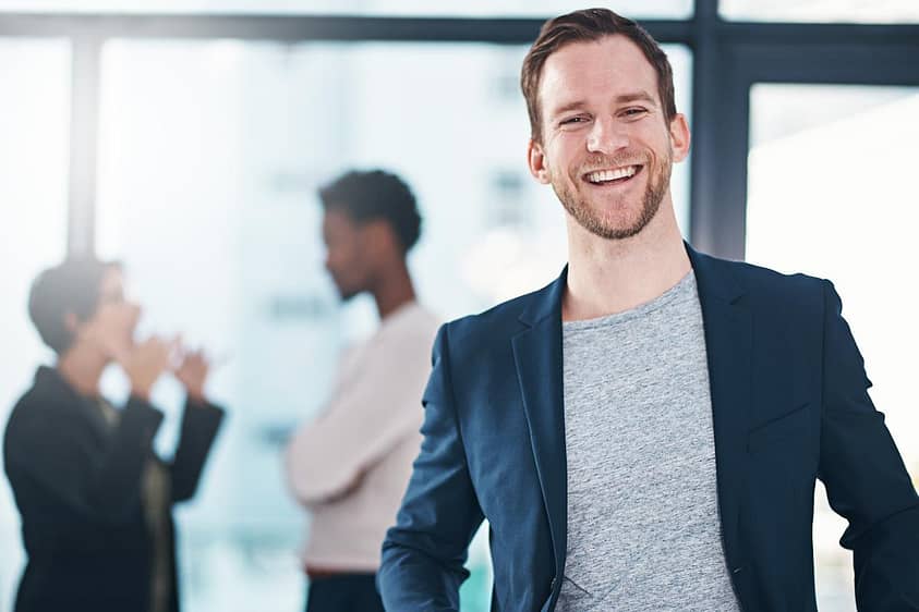 a man in a suit smiles in an executive drug rehab