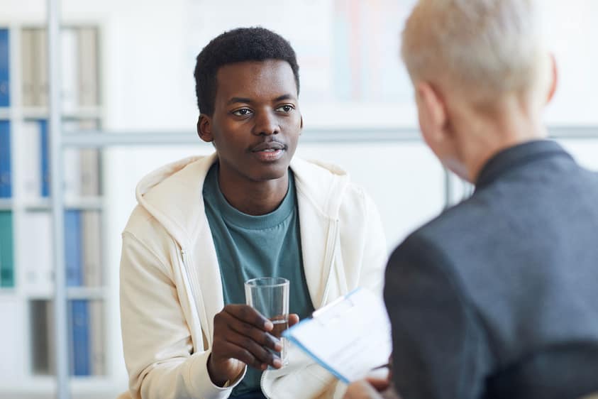 a man talks to a therapist about mental health stigma