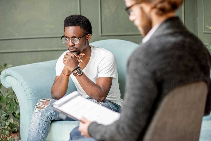 a man talks to a clinical therapist in asheville