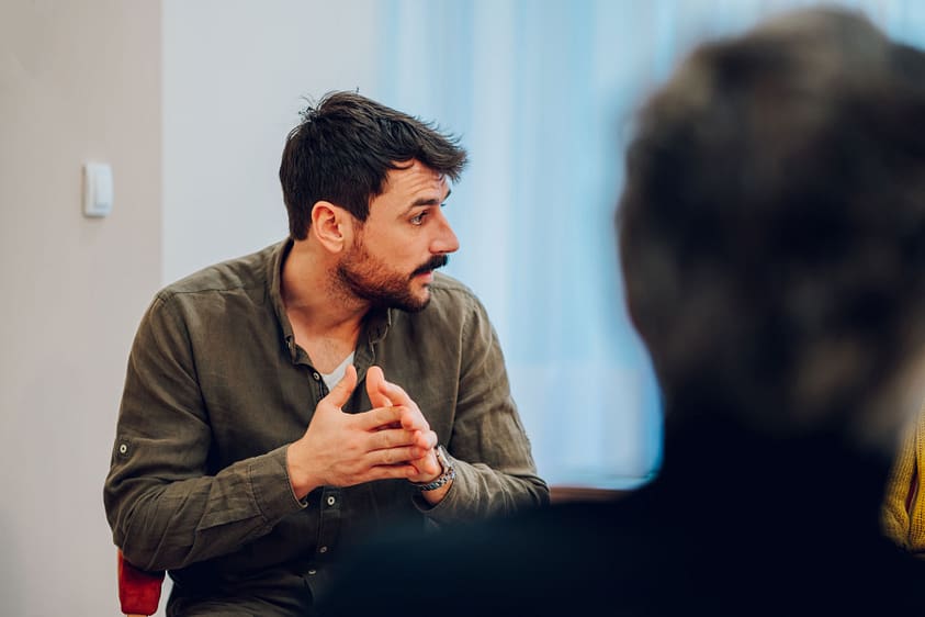 a man talks during group therapy at a trauma treatment center in Asheville