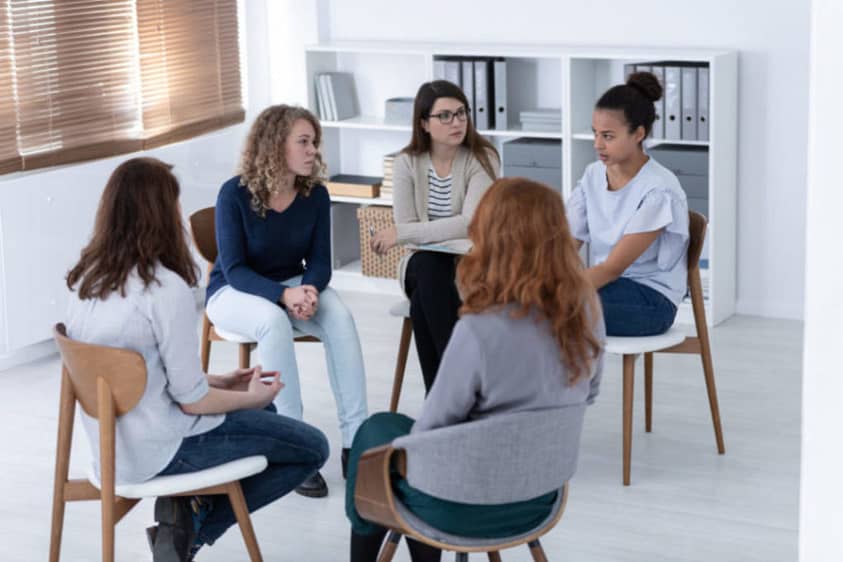 A group meeting at a women’s sober living house.