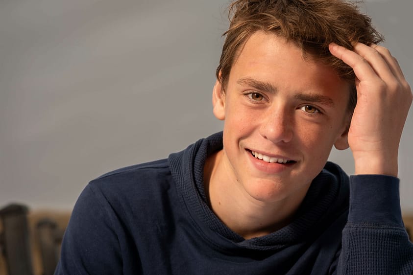 A teen male exhibiting smiling depression