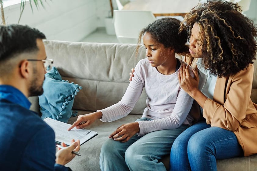 Therapist talks to mother and daughter about emerging treatments for panic disorder