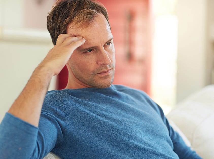 a man with bpd and alcohol addiction holds his head