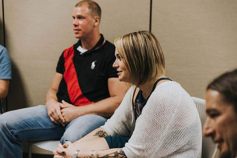 Female patient speaking in a drug rehab group therapy session