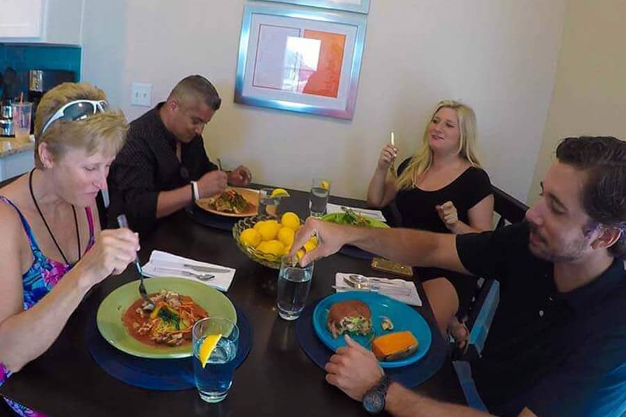 Patients in a drug rehab home eating dinner together