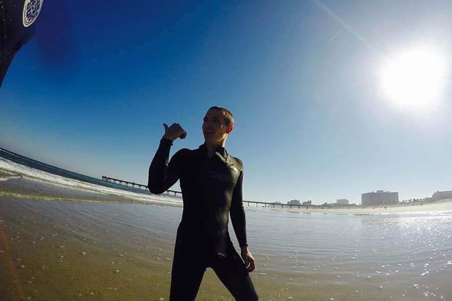 Man in a Wet Suit Standing on a Beach in Jacksonville