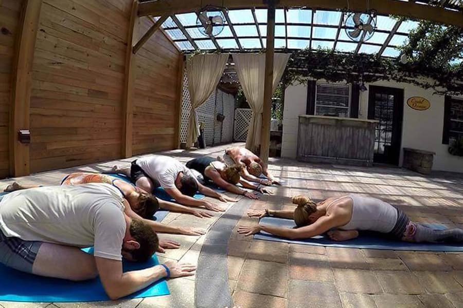 Woman guiding a yoga exercise session at Beaches Recovery